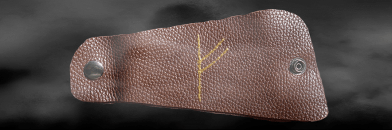 Fehu rune on skin as a good luck charm