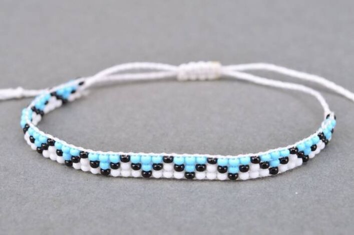 A bracelet made of threads and beads is an amulet that will bring good luck to the owner